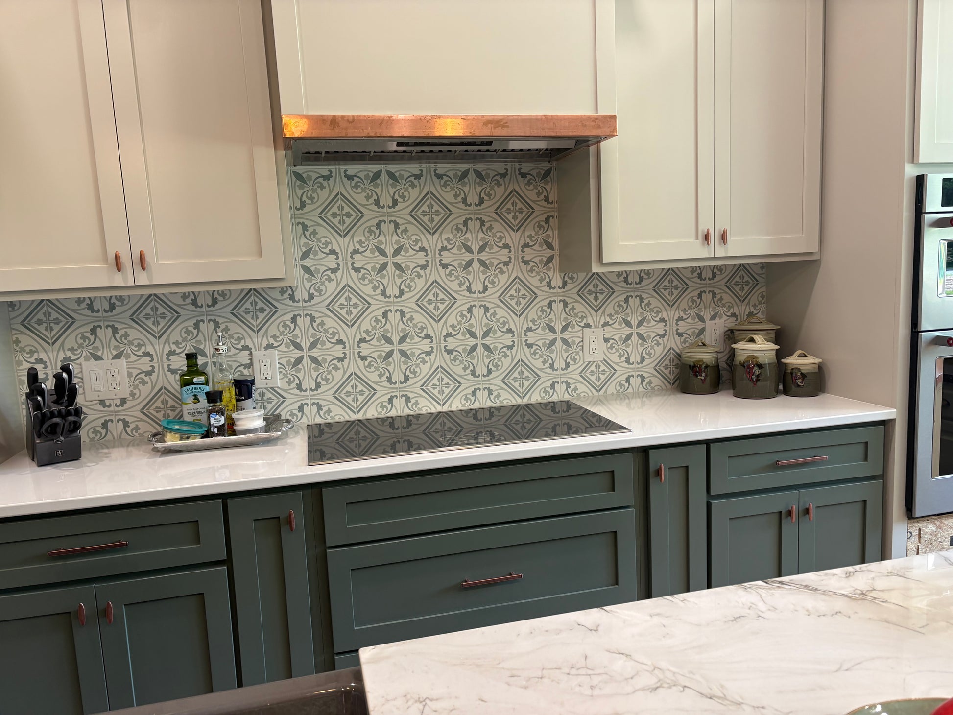 Modern kitchen with patterned backsplash and white countertops