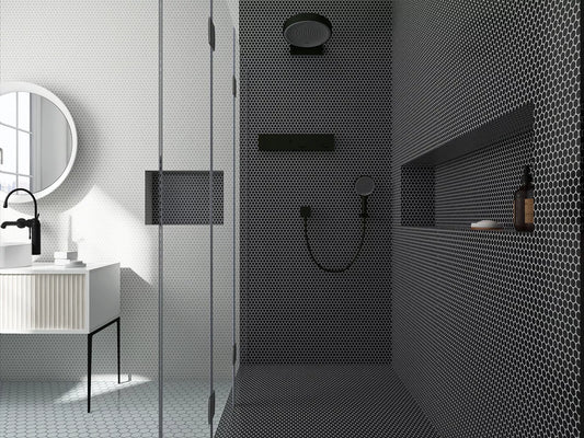 Modern bathroom with black tiled shower area and white vanity.