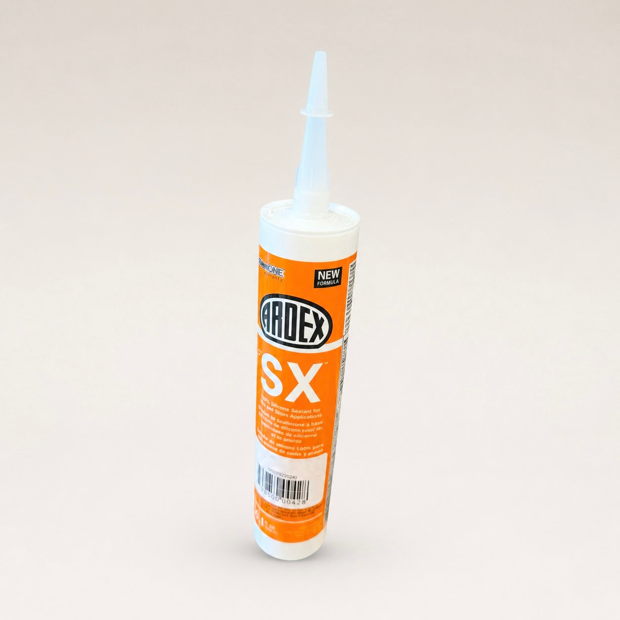 A tube of Ardex SX silicone sealant with an orange and white label, standing upright on a light beige background.