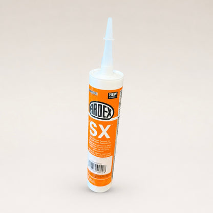 A tube of Ardex SX silicone sealant with an orange and white label, standing upright on a light beige background.