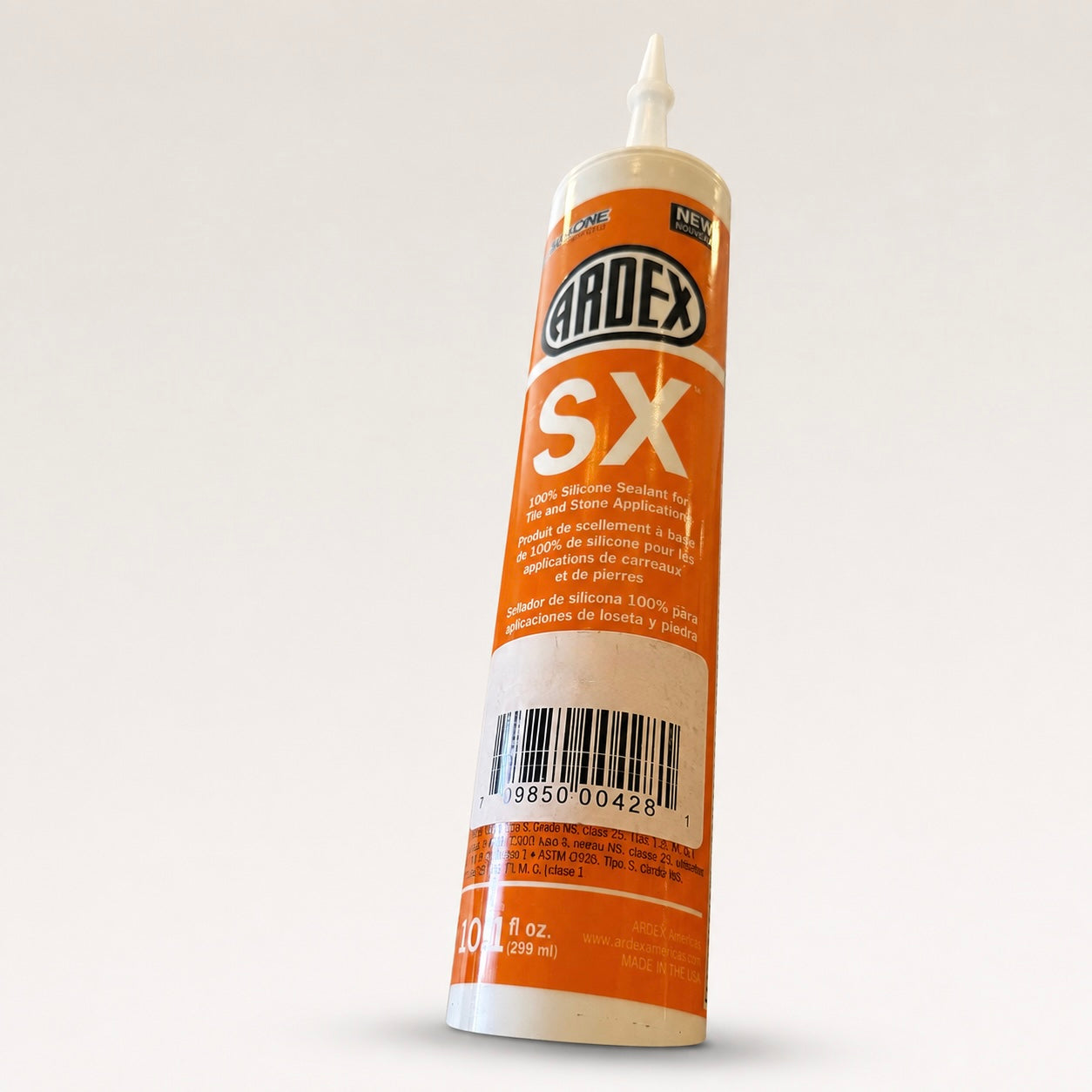 A single tube of Ardox SX silicone sealant standing upright on a plain light gray background. The tube is white with a large orange label and a white nozzle tip.