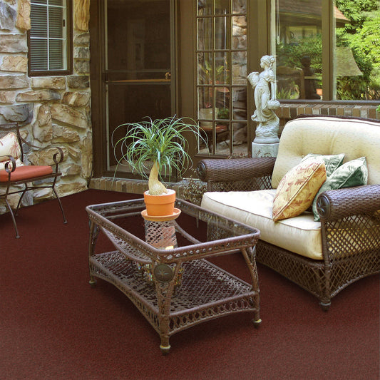 Artificial turf carpet in a red toned color, patterned with a brick-like appearance.