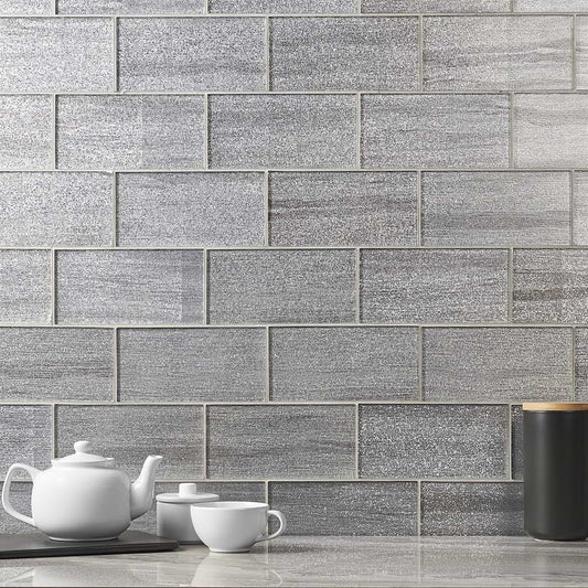 Gray brick-patterned tiles on a wall with kitchen items below