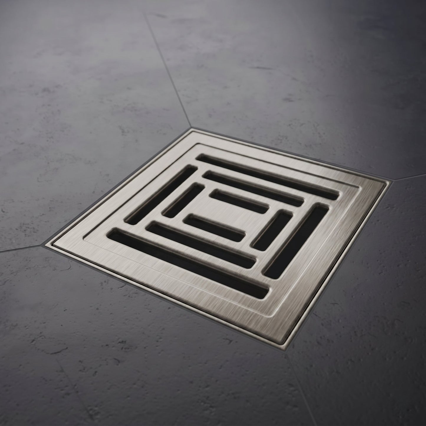 Square metal drain cover on a gray concrete floor