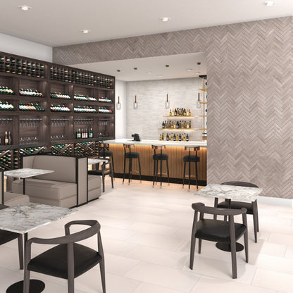 Modern bar interior with wine bottles, tables, and chairs.