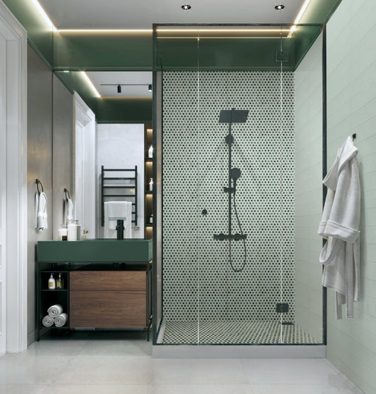 Modern bathroom with shower enclosure, vanity, and towel rack.