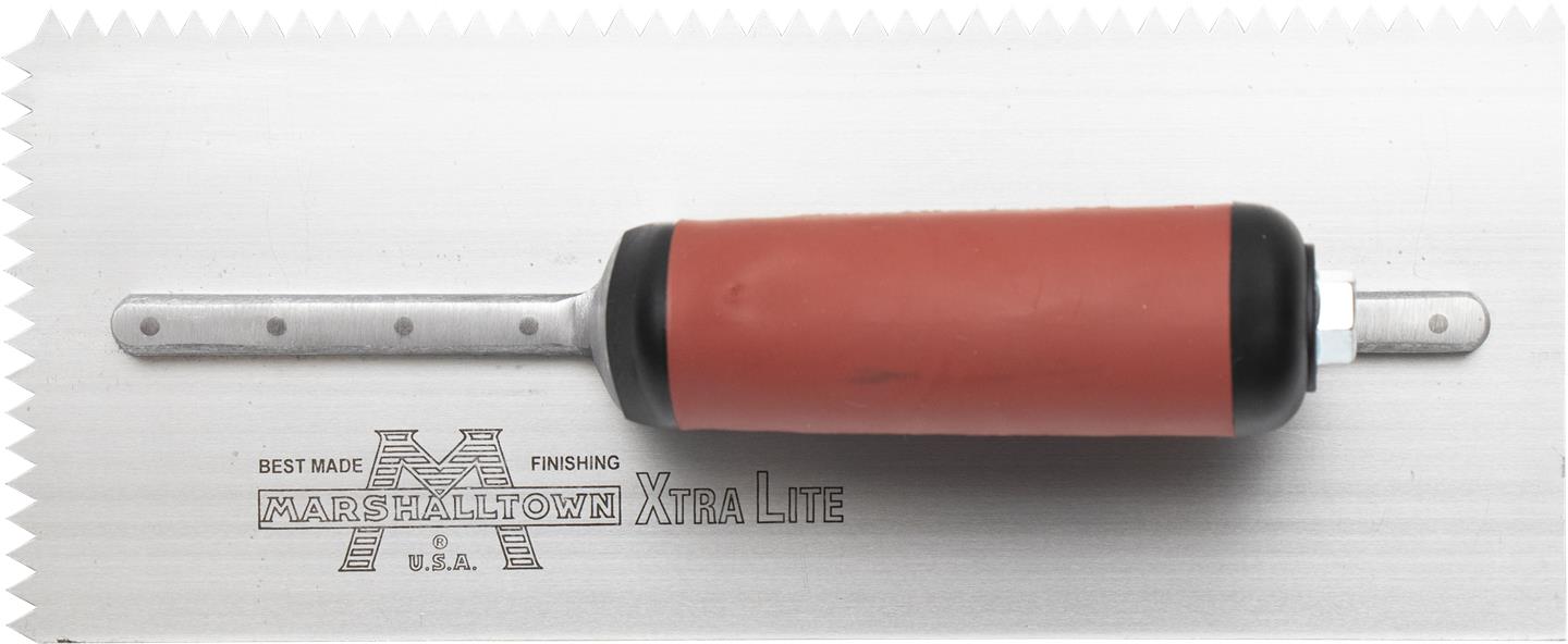 A V-Shaped Notched Trowel with an maroon handle and a silver blade, laying on a white surface.