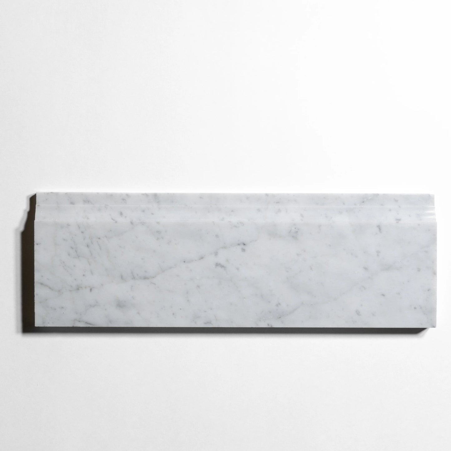 A rectangular white marble tile with natural gray veining, displayed horizontally against a clean white background.
