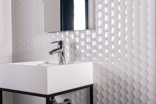 Bathroom with white hexagonal tiles on the wall and a sink.