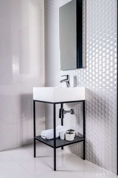 Bathroom with white sink, black shelf, and textured white wall.