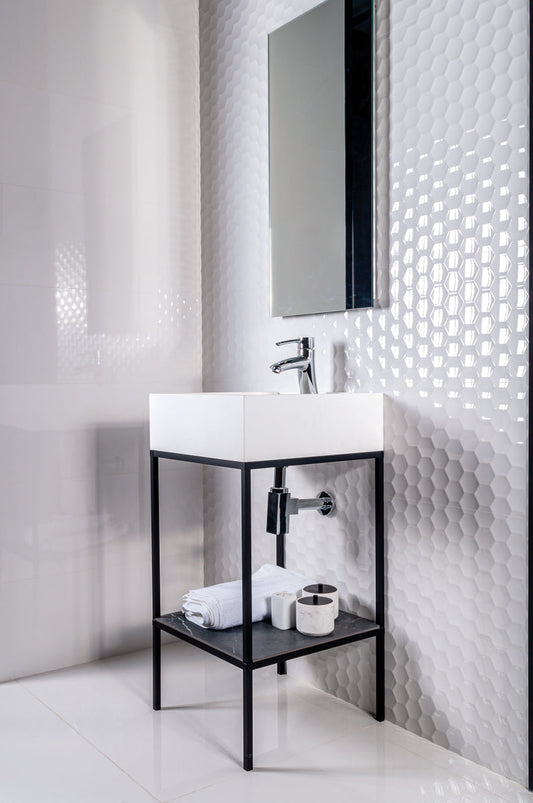 Bathroom with white sink, black shelf, and textured white wall.