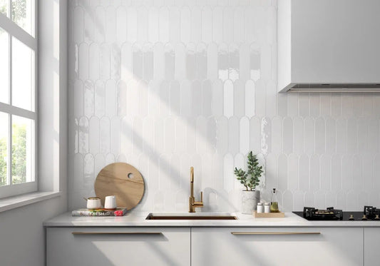 Modern kitchen with white tiled walls, a window, and kitchen appliances.