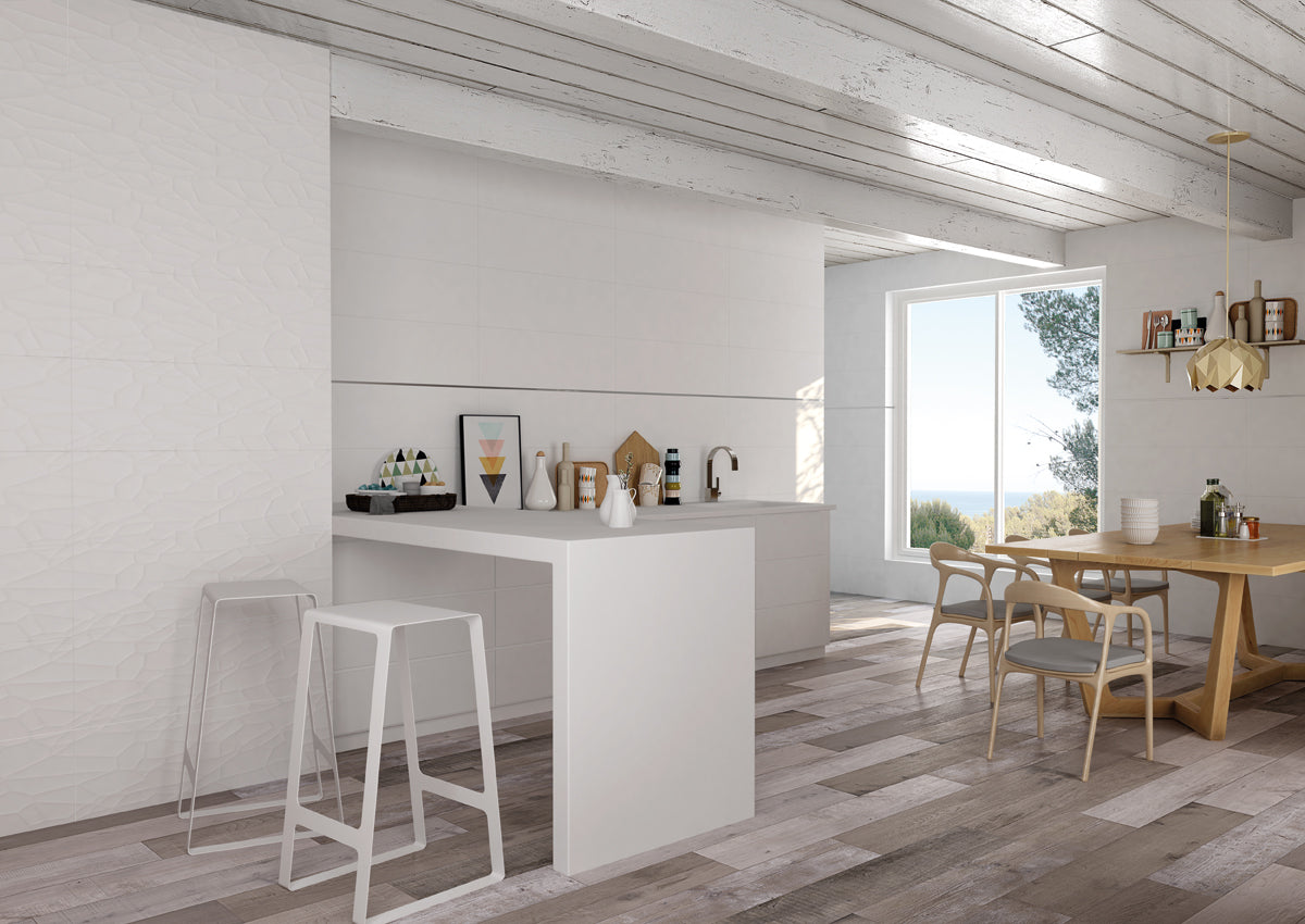 Modern kitchen with white island, stools, and wooden dining table with chairs.