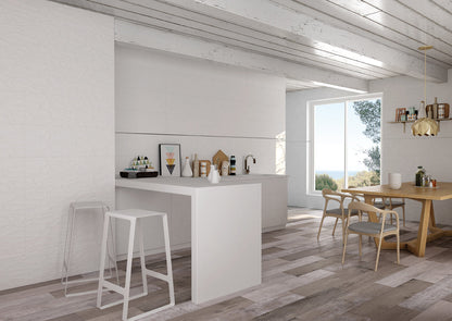 Modern kitchen with white island, stools, and wooden dining table with chairs.