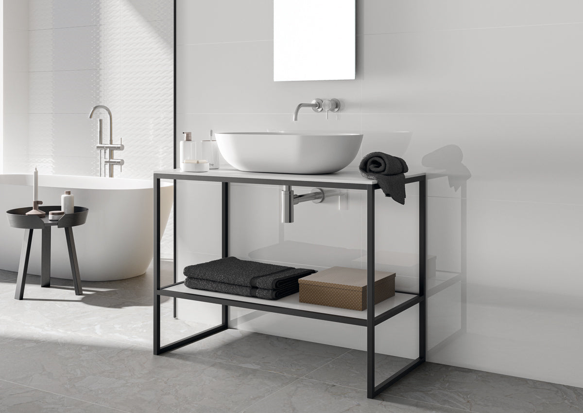 Bathroom with a black metal vanity unit, white sink, and towels.