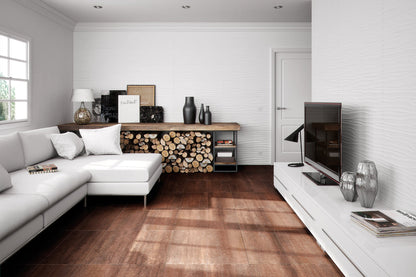 Modern living room with white sectional sofa, wooden floor, and decorative items.