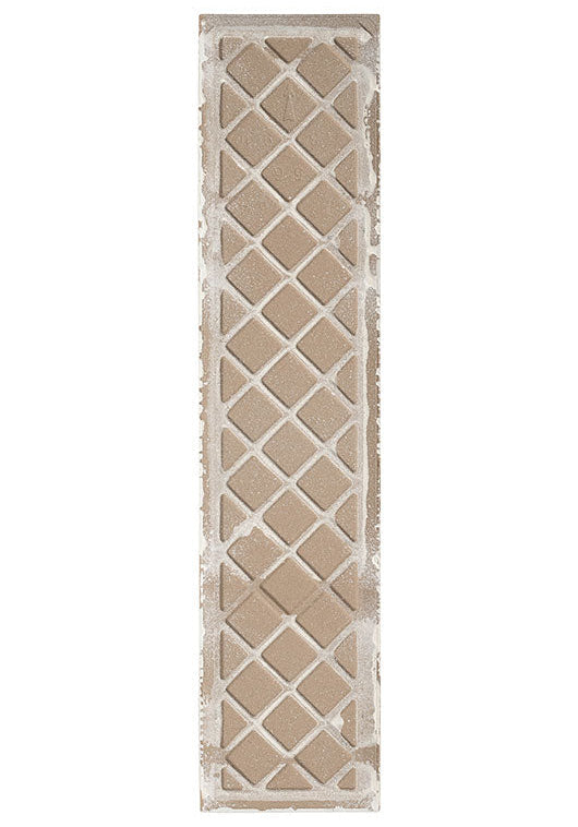 The back of a rectangular ceramic tile with a distressed lattice pattern, featuring a porcelain bisque and a white kiln release showing.